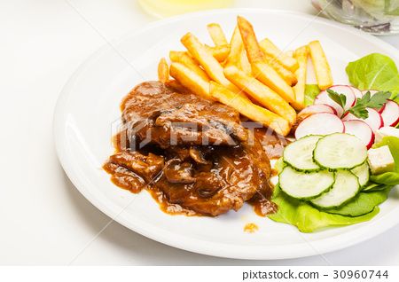 图库照片: pork chop with sauce, mushrooms and chips